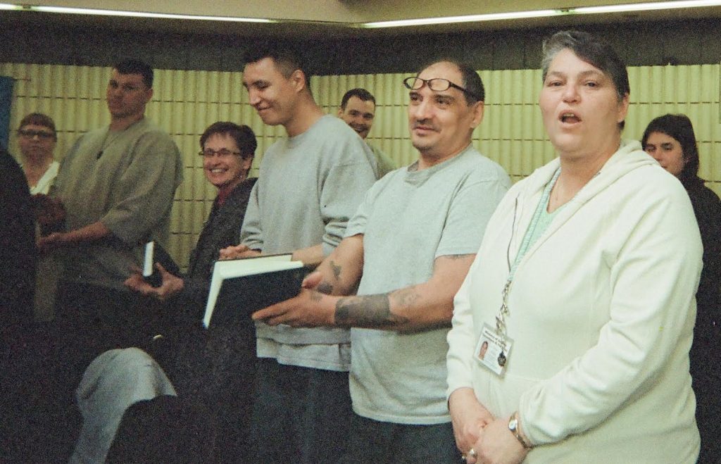 Restorative Justice – singing together A group singing from hymn books during a Restorative Justice service
