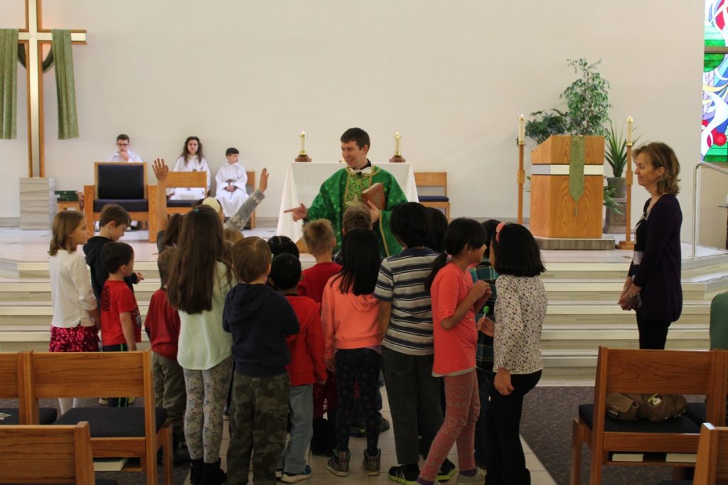 Children gathered at the front of the church during Children's Liturgy